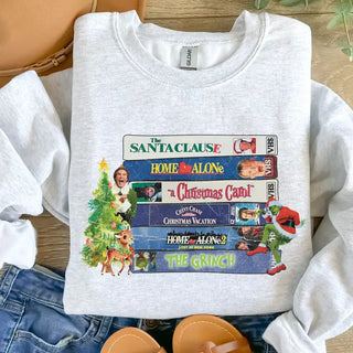 Christmas Movies Graphic Crewneck Sweatshirt is a gray sweatshirt with a classic Christmas movies graphic 