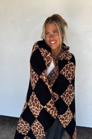 Checkered Cheetah Cloud Blanket is a black and cheetah print checkered blanket. 