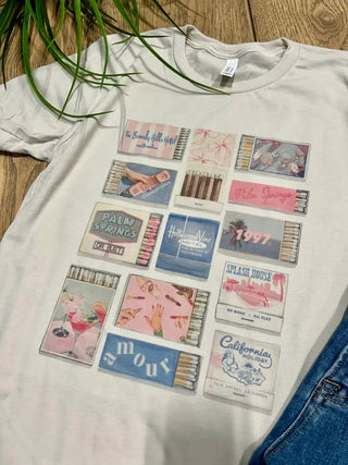 Vintage Match Box Graphic Tee is a heather oatmeal colored tee with pictures of various match boxes