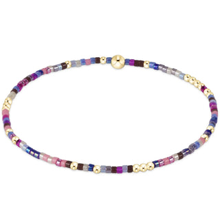 Too Glam To Give a Jam is a multicolored beaded bracelet with gold accents