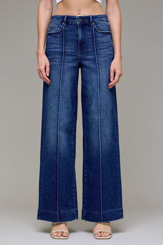 Dark Wash Pintuck High Rise Wide Leg Jeans by Hidden are a pair of dark wash wide leg jeans with pintuck detail. 