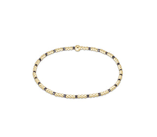 enewton Hope Sincerity Pattern 2mm Bead Bracelet - Taupe With A Twist is a bracelet with taupe and gold beads. 