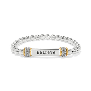 Brighton Meridian Believe Two Tone Stretch Bracelet is a silver bracelet with a bar charm displaying the word 'BELIEVE' 